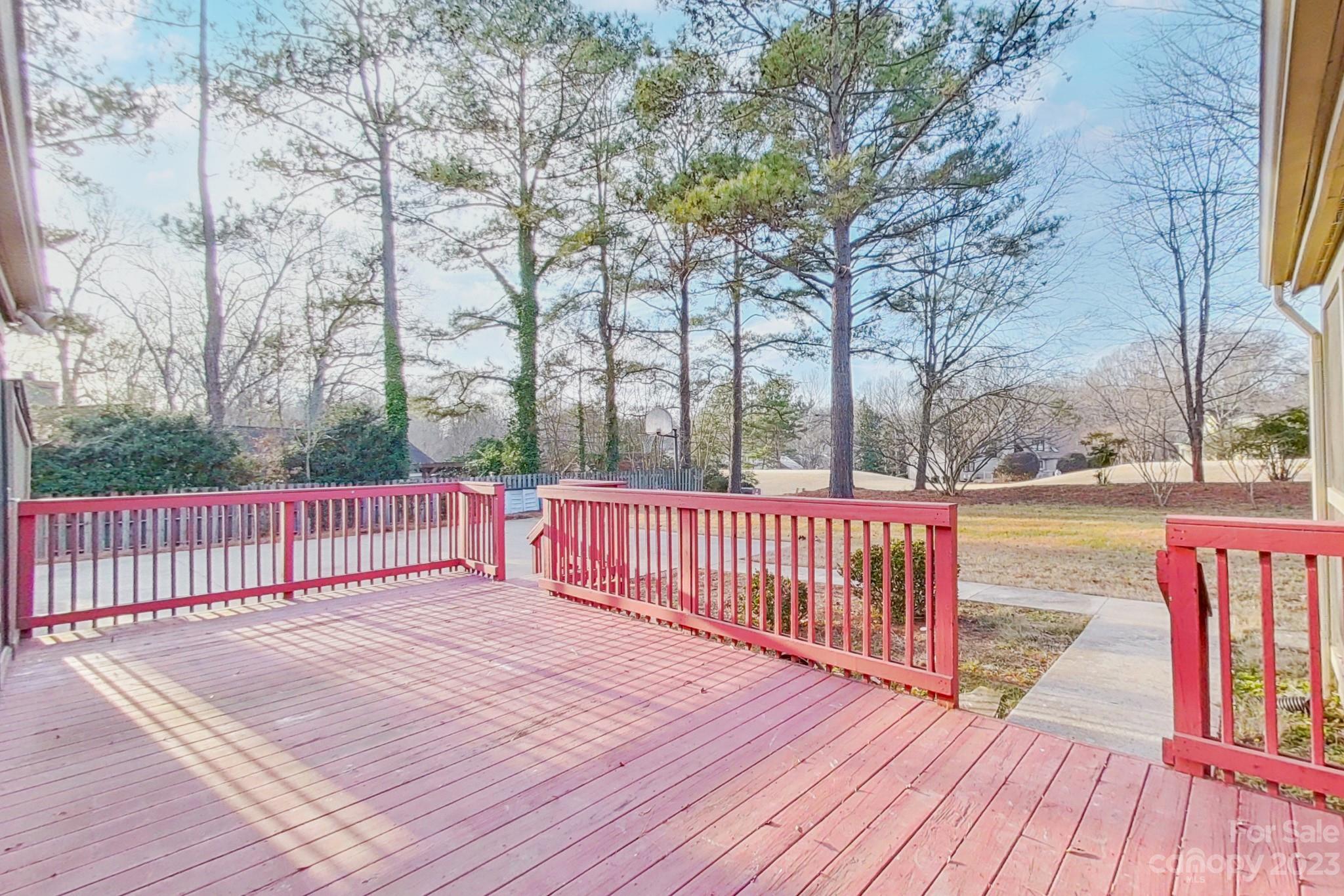 4810 Rounding Run Road Charlotte, NC 28277 - Photo 11 of 42 a balcony with wooden floor and trees