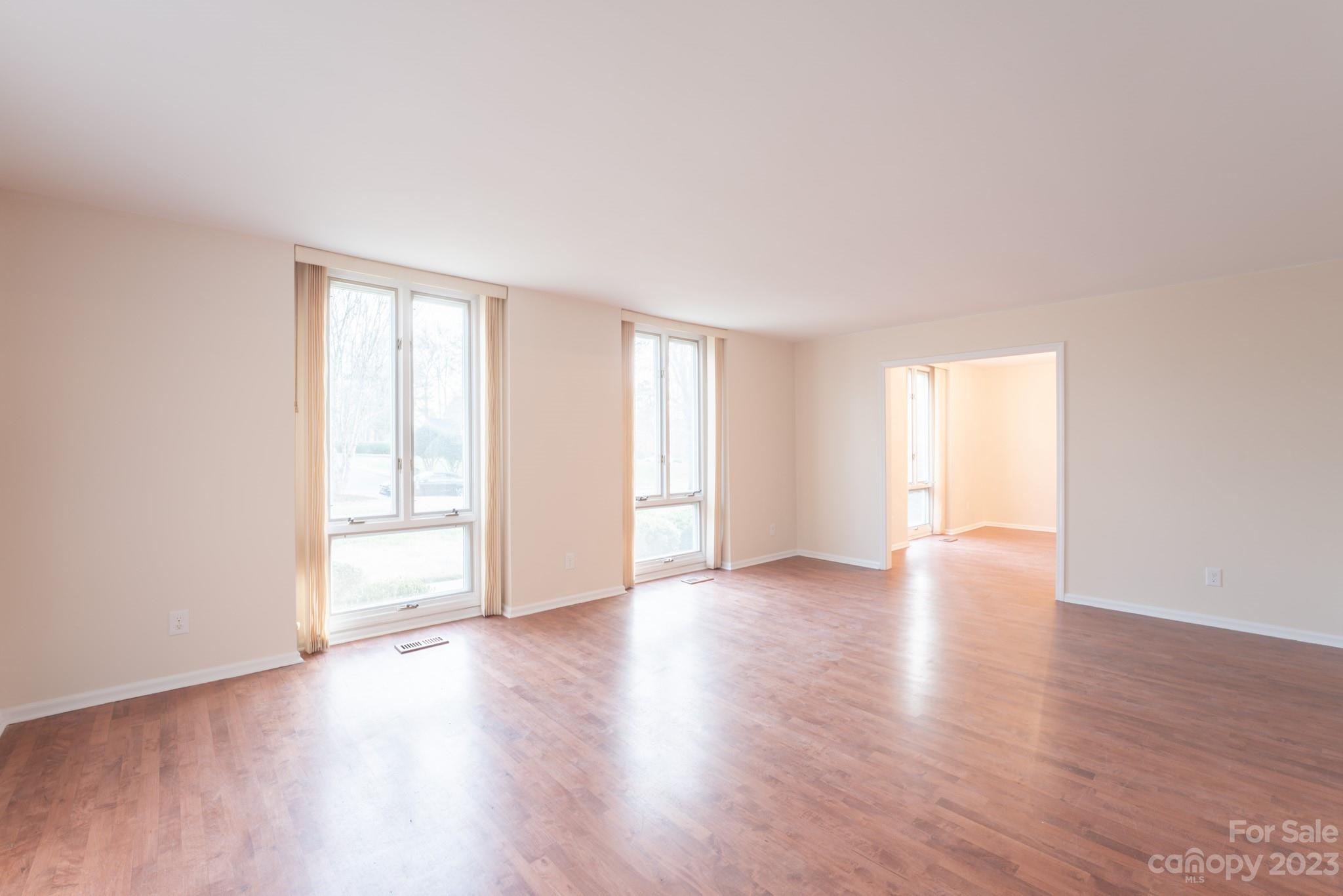 4810 Rounding Run Road Charlotte, NC 28277 - Photo 14 of 42 a view of an empty room with wooden floor and window
