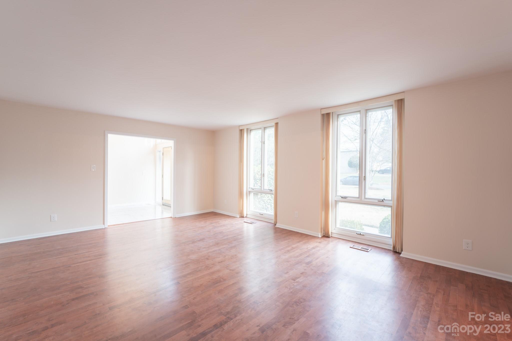 4810 Rounding Run Road Charlotte, NC 28277 - Photo 16 of 42 a view of an empty room with wooden floor and window