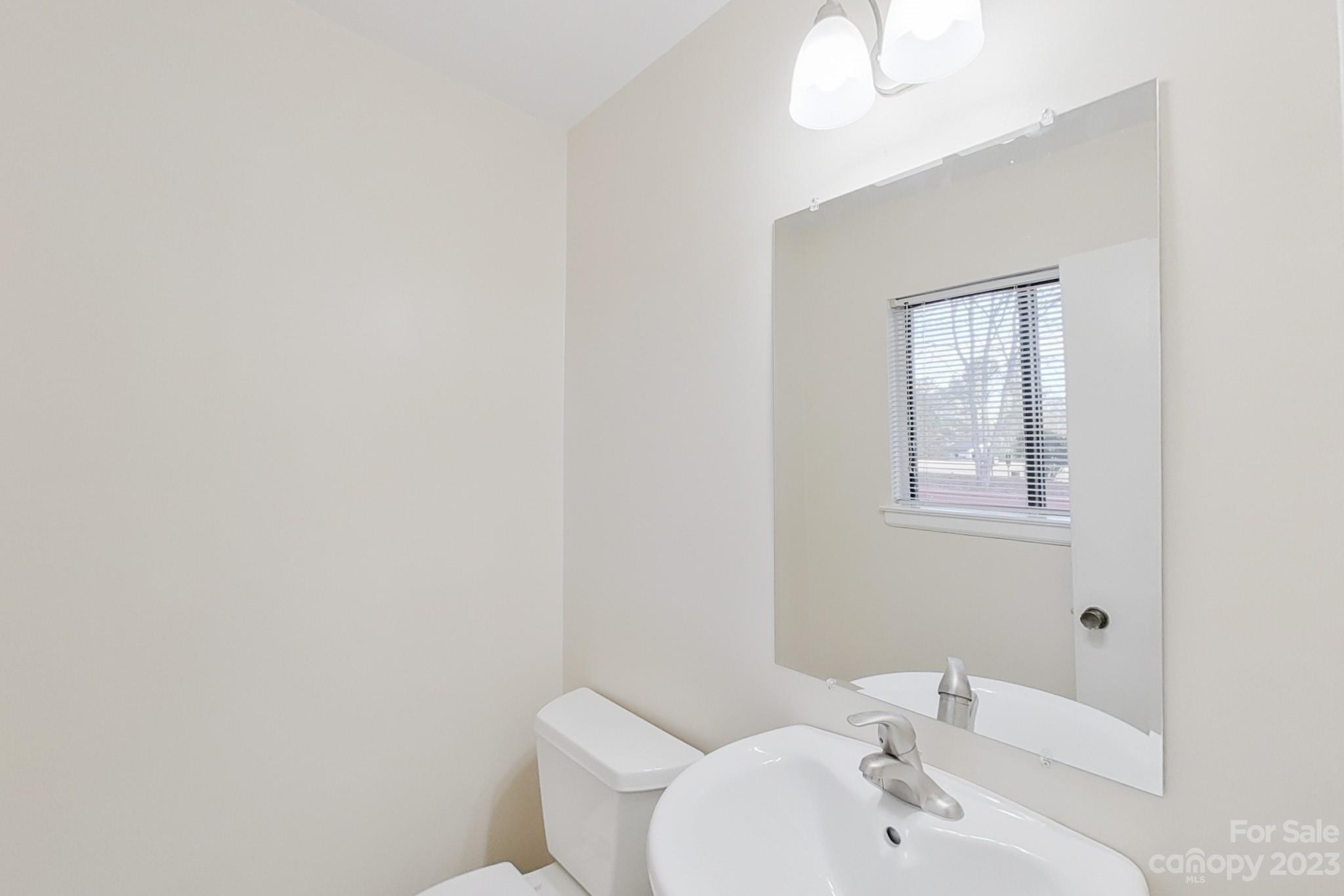 4810 Rounding Run Road Charlotte, NC 28277 - Photo 20 of 42 a bathroom with a sink mirror and toilet