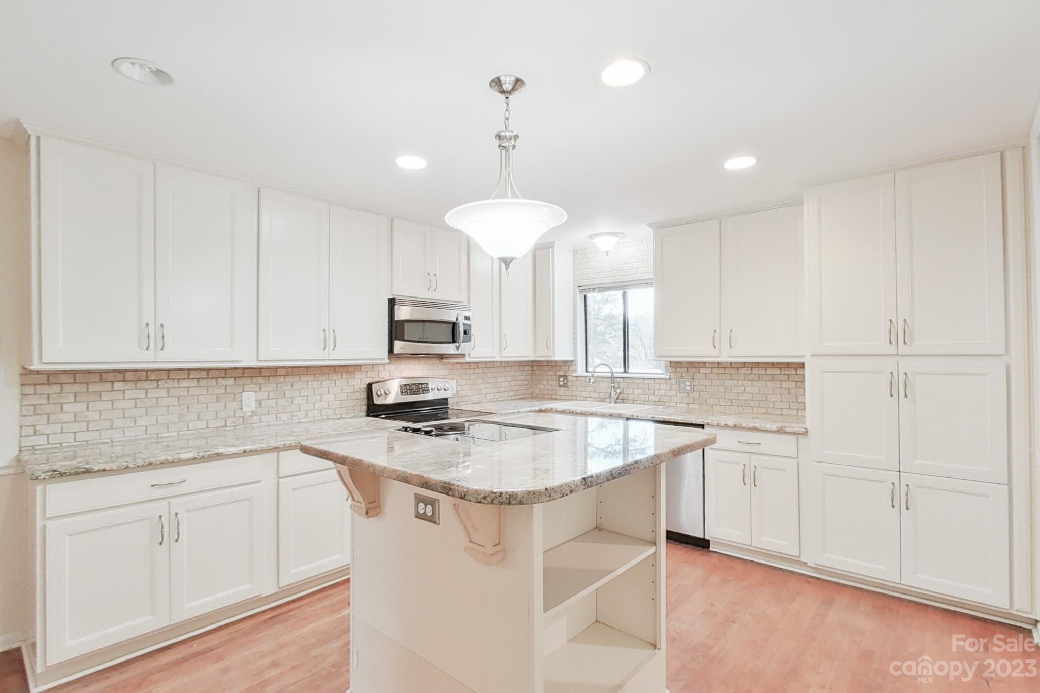 4810 Rounding Run Road Charlotte, NC 28277 - Photo 22 of 42 a kitchen with stainless steel appliances granite countertop a sink a stove a refrigerator and white cabinets
