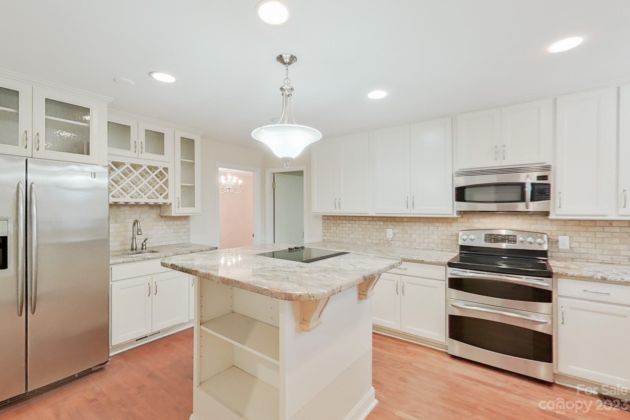 4810 Rounding Run Road Charlotte, NC 28277 - Photo 23 of 42 a kitchen with stainless steel appliances granite countertop a sink and a refrigerator