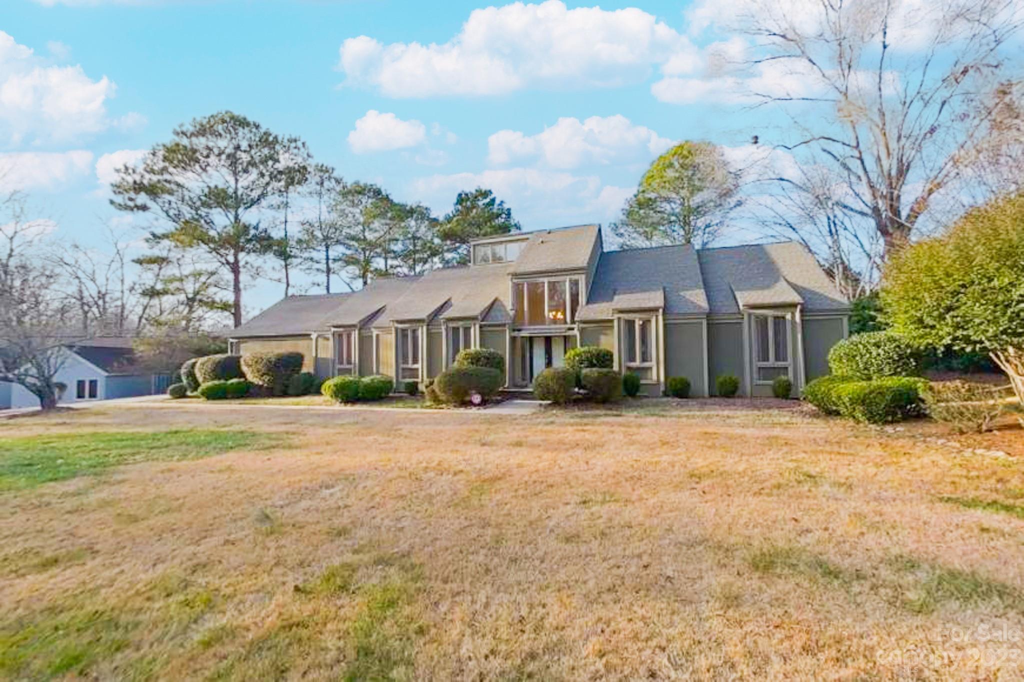 4810 Rounding Run Road Charlotte, NC 28277 - Photo 4 of 42 a front view of house with yard and trees around