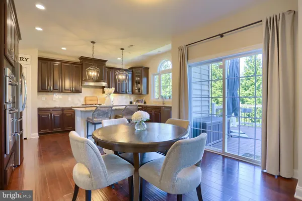 a kitchen with granite countertop wooden floors and stainless steel appliances