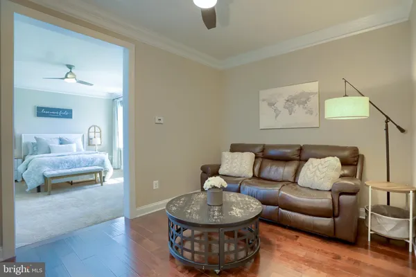 a bedroom with a bed mirror and furniture