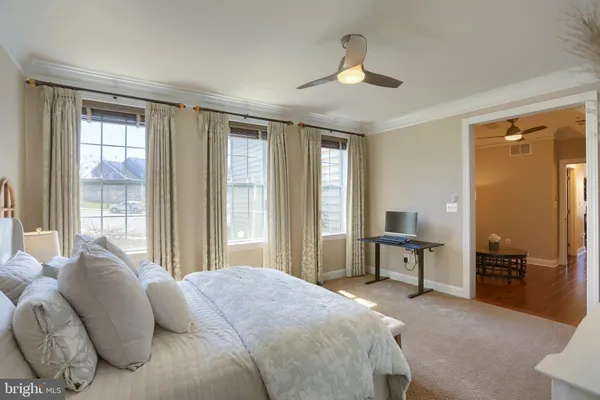 a spacious bedroom with a bed and a couch