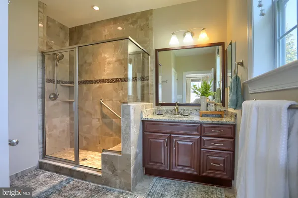 a spacious bedroom with a bed and a flat screen television