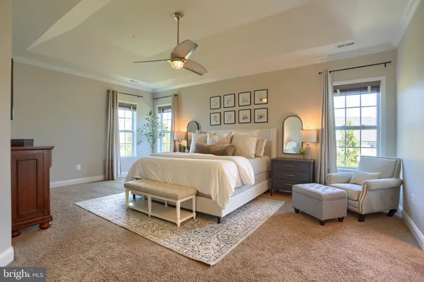 a living room with furniture a bookshelf and a window