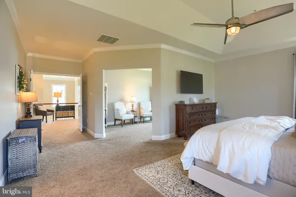 a spacious bathroom with a granite countertop sink and a mirror