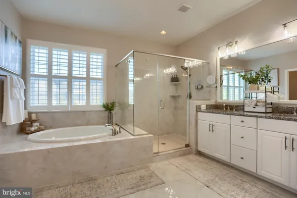a bathroom with a granite countertop sink toilet and a mirror