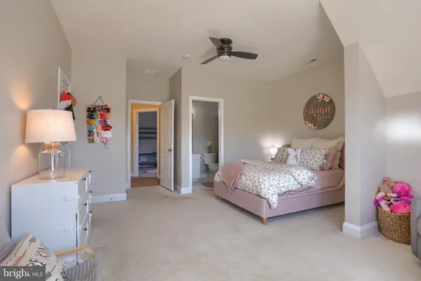 a living room with furniture a flat screen tv and a table
