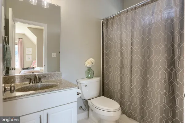 a living room with furniture a rug and a book shelf