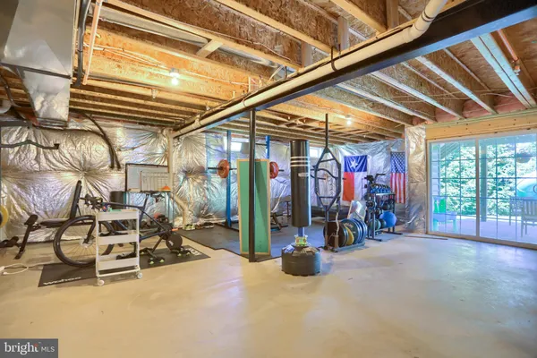 a view of a patio with table and chairs potted plants and large tree