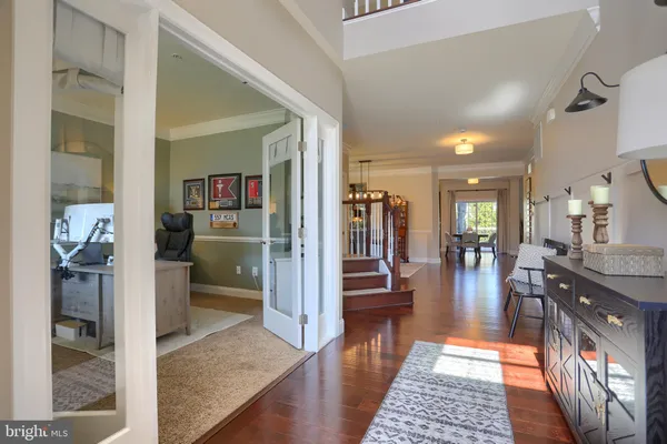a hallway with dining table and chairs