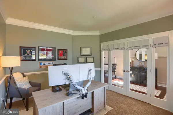 a view of an entryway with wooden floor and livingroom view