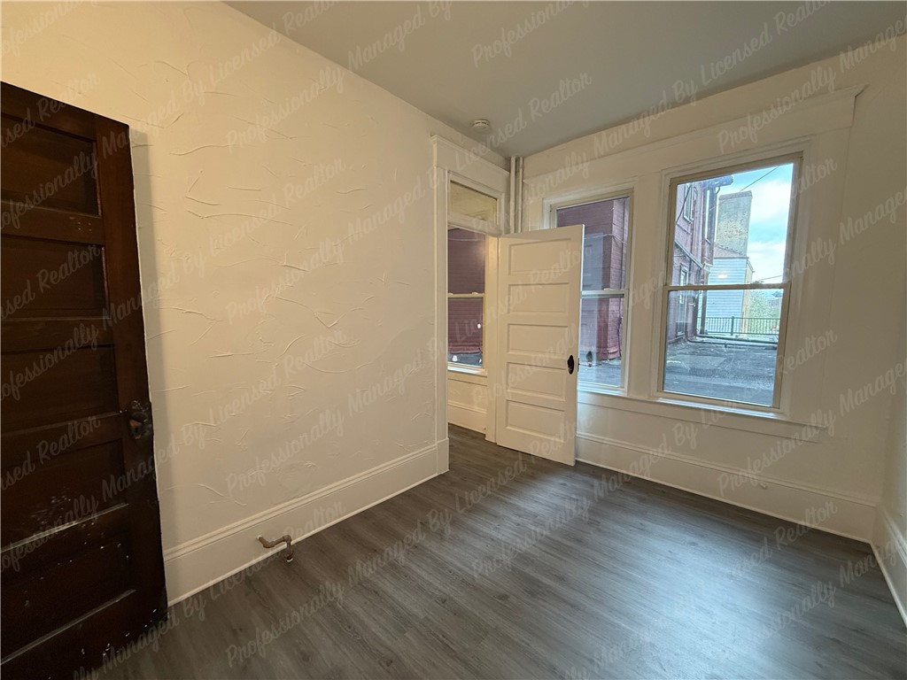 44 West High Street, Unit B Springfield, OH 45502 - Photo 20 of 31 This interior offers abundant natural light, creating a bright and inviting atmosphere.