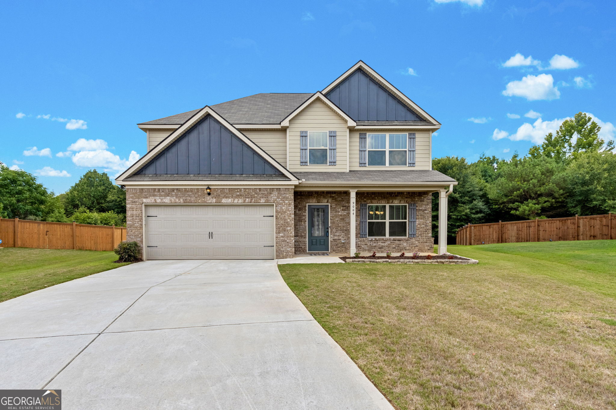 9004 Holder Road Locust Grove, GA 30248 - Photo 1 of 1 a front view of a house with a yard and garage