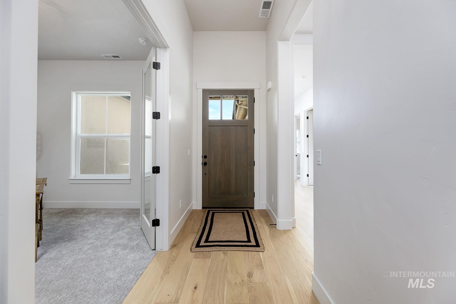 13660 North Spring Creek Way Boise, ID 83714 - Photo 17 of 42 Entrance foyer with light wood-style flooring and baseboards