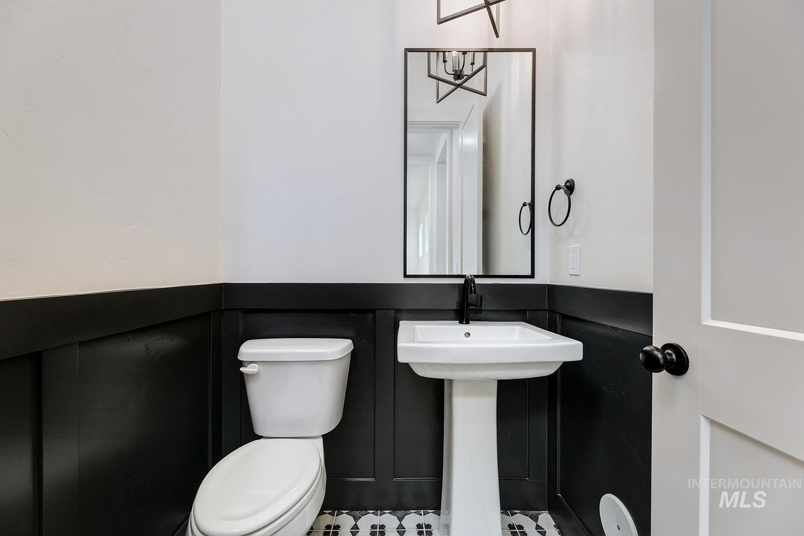 13660 North Spring Creek Way Boise, ID 83714 - Photo 20 of 42 Half bath featuring toilet and a wainscoted wall