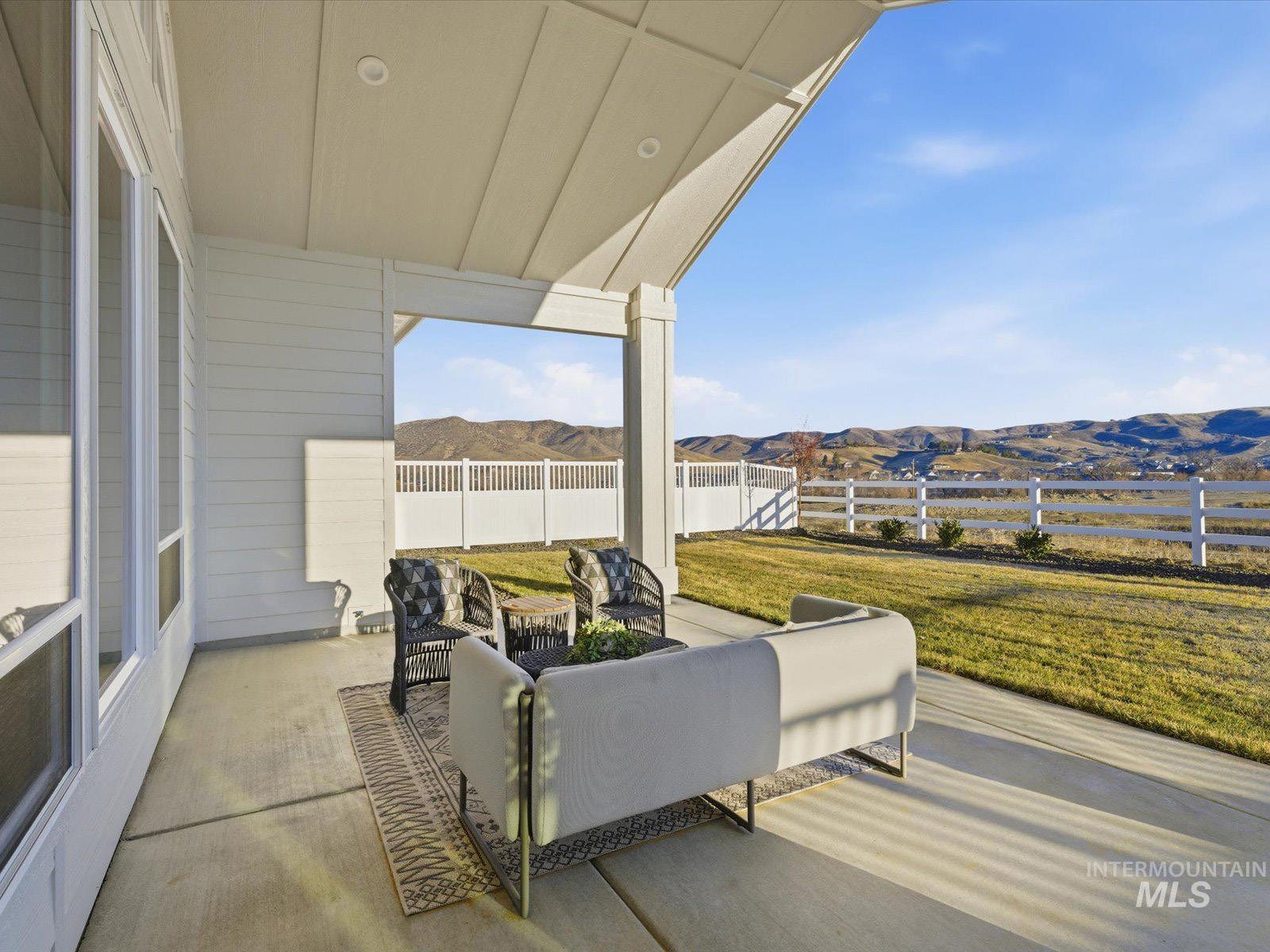 13660 North Spring Creek Way Boise, ID 83714 - Photo 27 of 42 Fenced backyard with a mountain view, a patio area, and outdoor seating