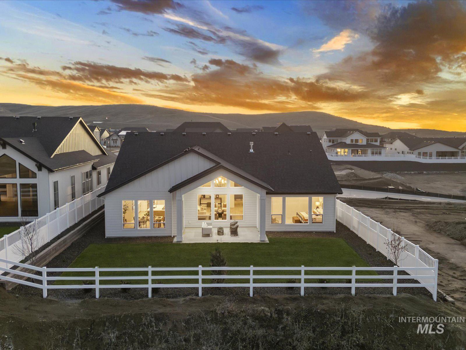13660 North Spring Creek Way Boise, ID 83714 - Photo 29 of 42 Back of property featuring a fenced backyard and a patio area