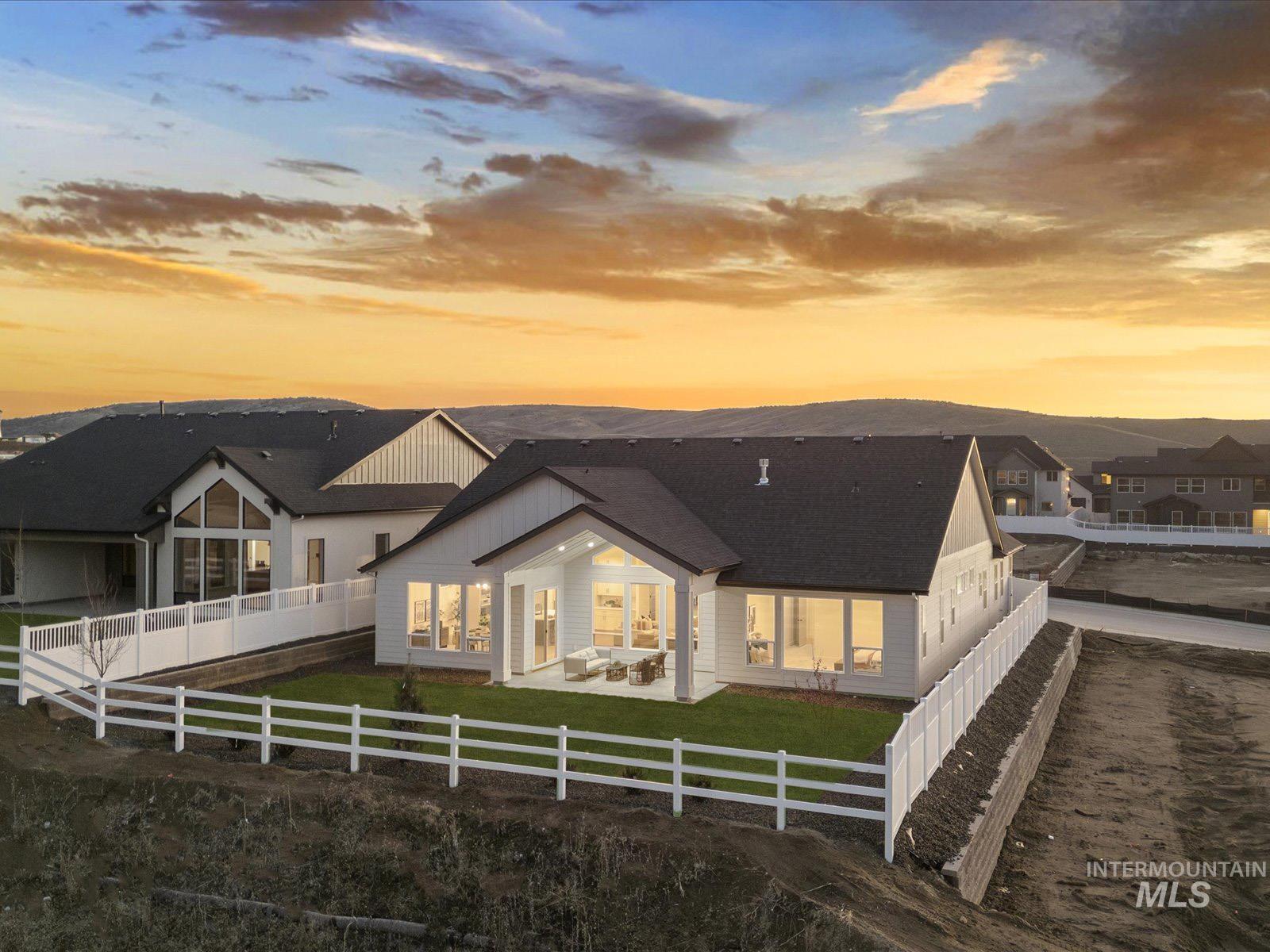 13660 North Spring Creek Way Boise, ID 83714 - Photo 30 of 42 Rear view of property featuring a fenced backyard, a patio, roof with shingles, and board and batten siding