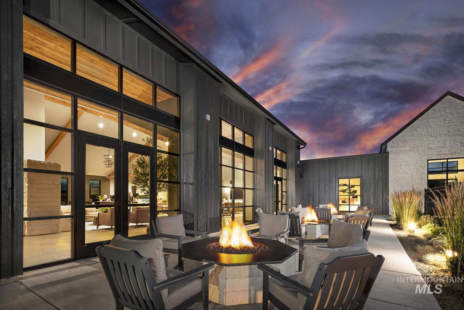 13660 North Spring Creek Way Boise, ID 83714 - Photo 39 of 42 Patio terrace at dusk with a patio and a fire pit