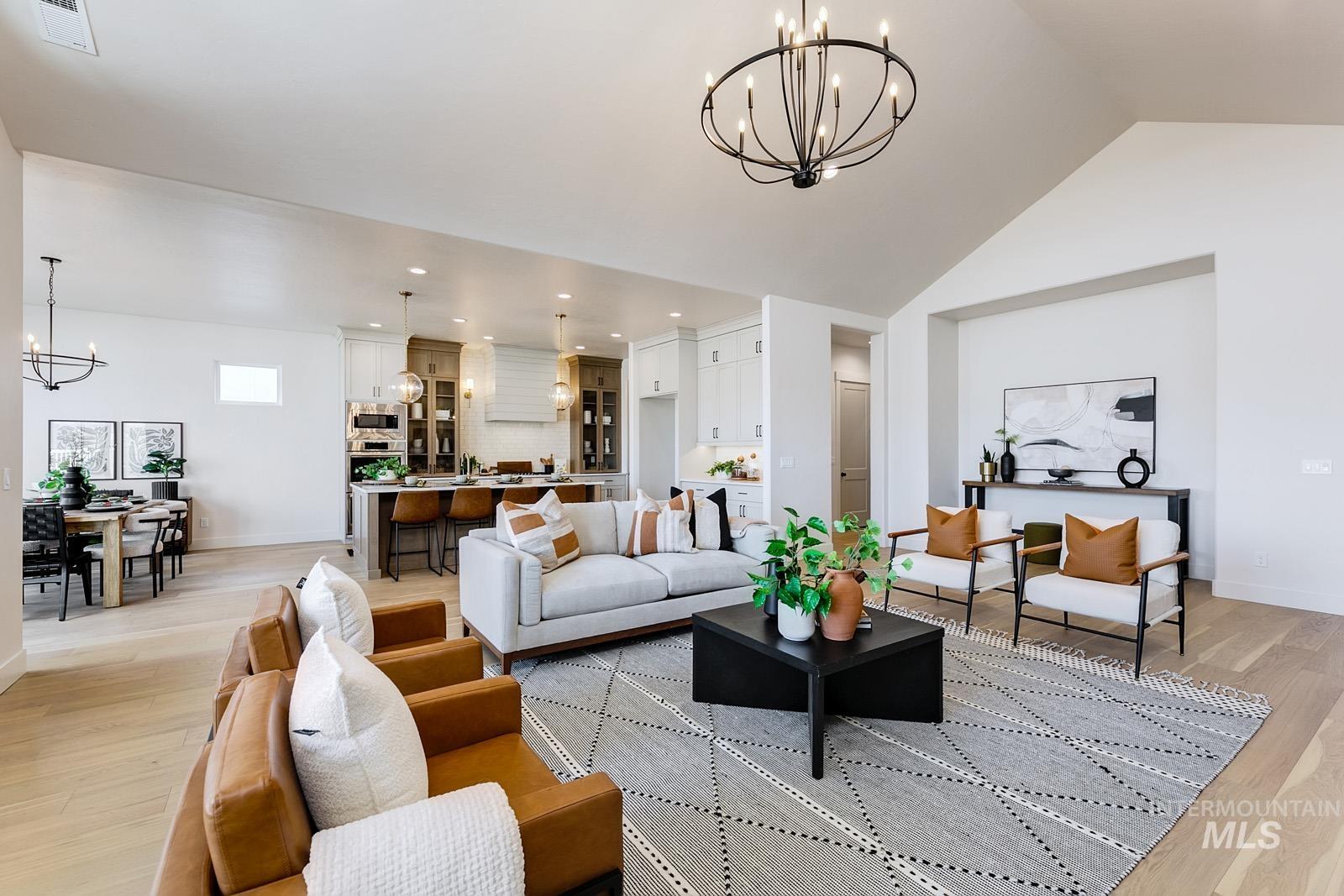13660 North Spring Creek Way Boise, ID 83714 - Photo 5 of 42 Living area with a chandelier and light wood-style flooring
