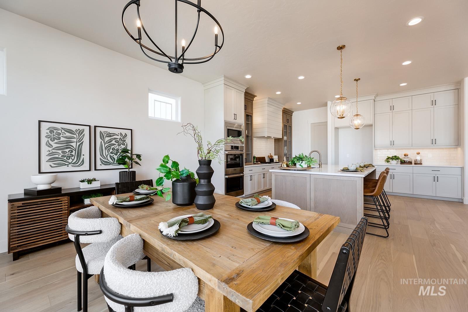 13660 North Spring Creek Way Boise, ID 83714 - Photo 9 of 42 Dining room featuring a chandelier and light wood-type flooring