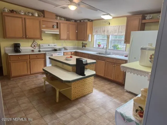 a kitchen with a sink appliances and cabinets