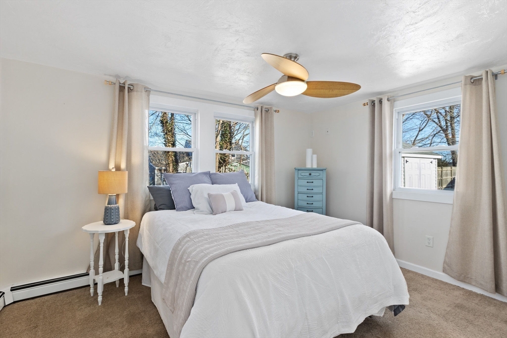 189 Wompatuck Road Hingham, MA 02043 - Photo 16 of 40 a bedroom with a bed and a large window