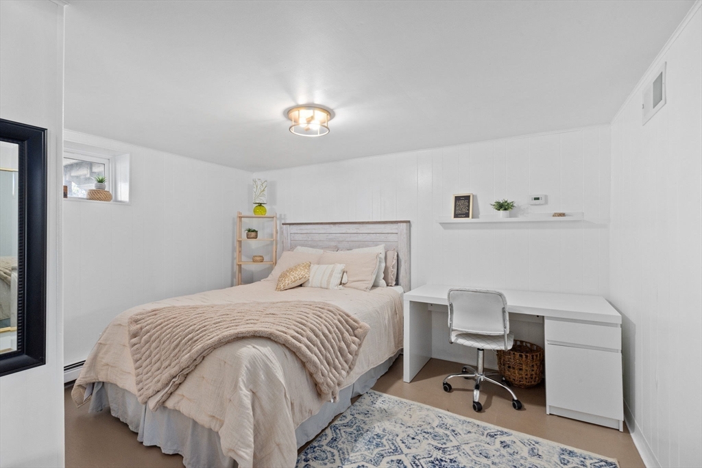 189 Wompatuck Road Hingham, MA 02043 - Photo 30 of 40 a bedroom with a bed a chair and painting on the wall