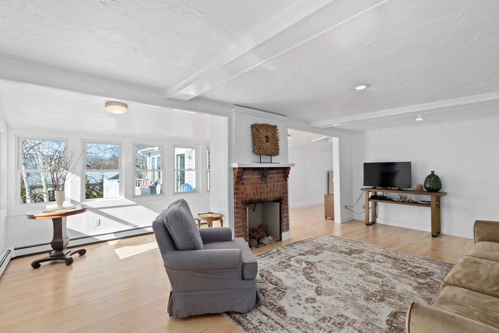 189 Wompatuck Road Hingham, MA 02043 - Photo 6 of 40 a living room with furniture a fireplace and a flat screen tv
