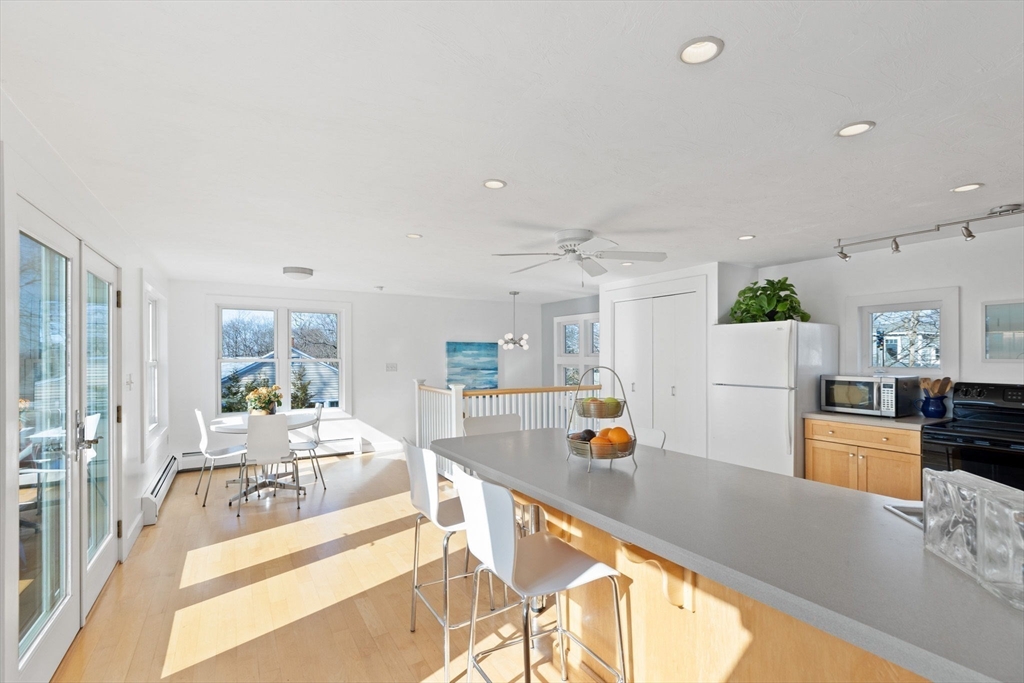 189 Wompatuck Road Hingham, MA 02043 - Photo 7 of 40 a living room with furniture and a kitchen area