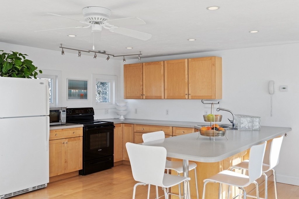 189 Wompatuck Road Hingham, MA 02043 - Photo 9 of 40 a kitchen with a table chairs stove and refrigerator