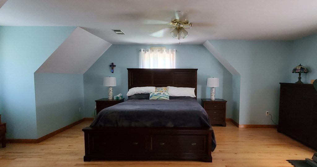 332 Lower Hampden Road Monson, MA 01057 - Photo 15 of 30 a bedroom with a bed and a chandelier