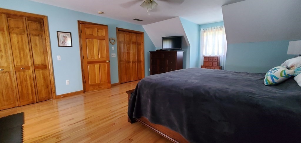 332 Lower Hampden Road Monson, MA 01057 - Photo 16 of 30 a bedroom with a bed and wooden floor