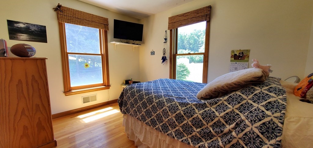 332 Lower Hampden Road Monson, MA 01057 - Photo 19 of 30 a bedroom with a bed and wooden floor