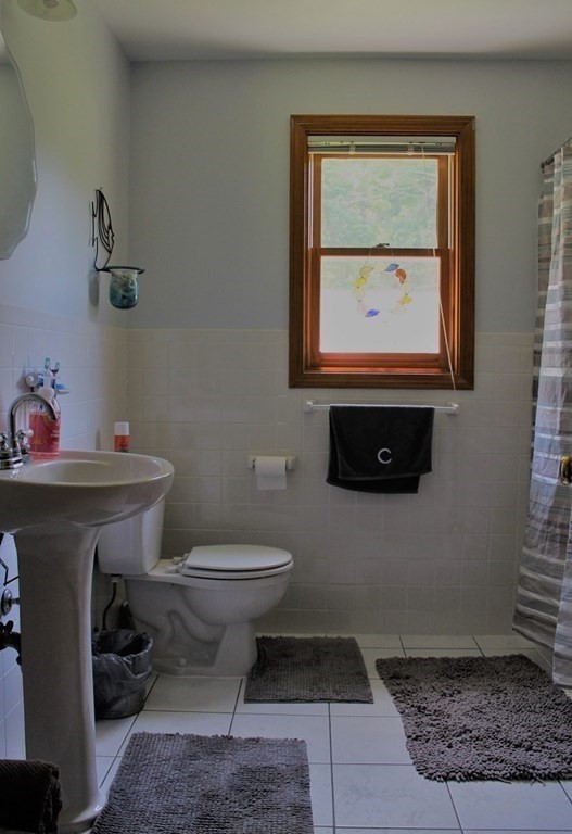 332 Lower Hampden Road Monson, MA 01057 - Photo 24 of 30 a bathroom with a toilet a sink and mirror