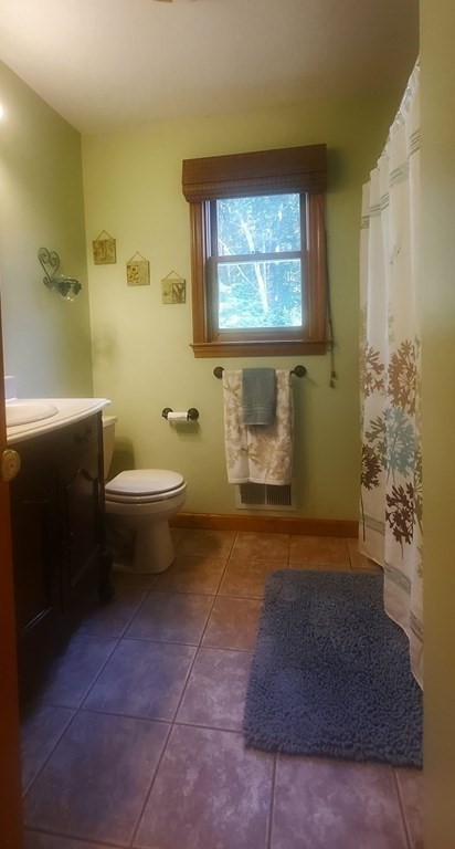 332 Lower Hampden Road Monson, MA 01057 - Photo 25 of 30 a bathroom with a toilet a sink and mirror