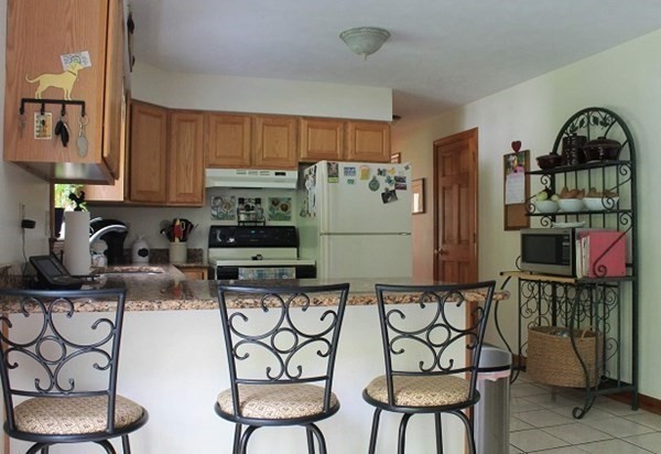 332 Lower Hampden Road Monson, MA 01057 - Photo 6 of 30 a kitchen with stainless steel appliances granite countertop a refrigerator and a stove top oven