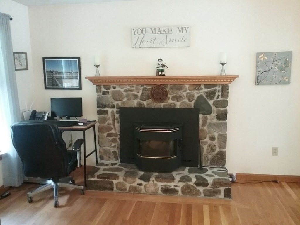 332 Lower Hampden Road Monson, MA 01057 - Photo 10 of 30 a living room with furniture a flat screen tv and a fireplace