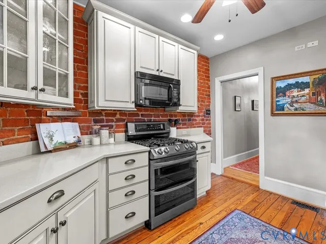 a kitchen with stainless steel appliances granite countertop a stove and a sink
