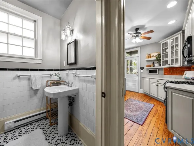 a bathroom with a sink a mirror and a bathtub