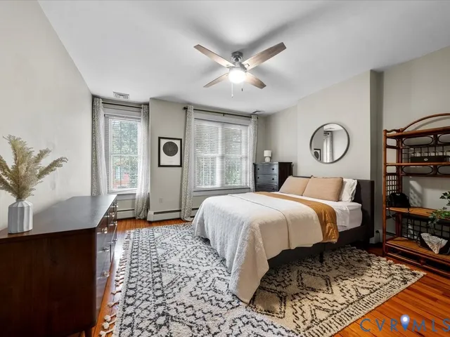 a bedroom with a large bed and a window