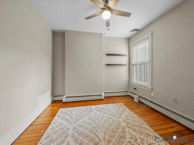 wooden floor in an empty room with a window