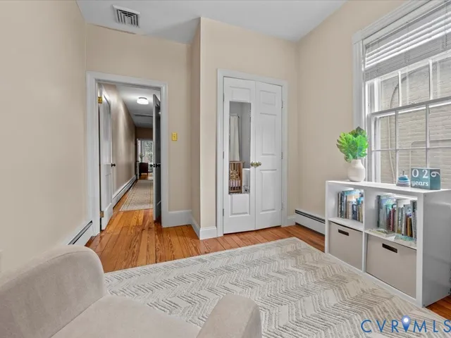 a bedroom with furniture and a book shelf