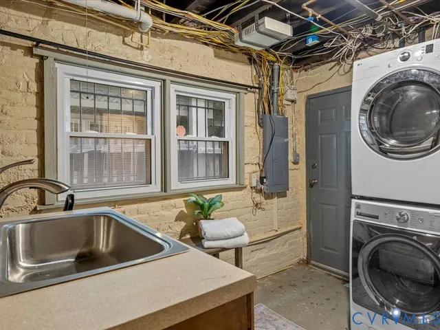 a utility room with sink dryer and washer