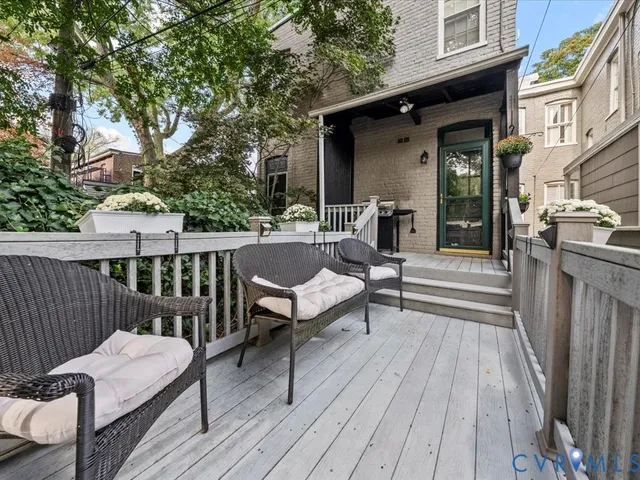 a view of a two chairs and table on the deck