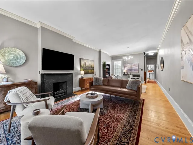 a living room with furniture a fireplace and a flat screen tv